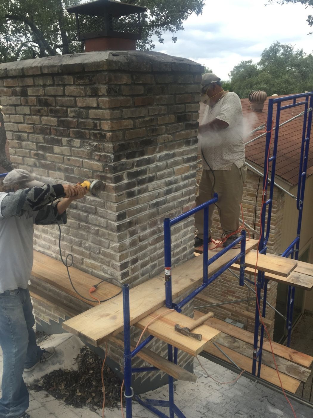 Specialists repairing a chimney to ensure structural stability and weather resistance