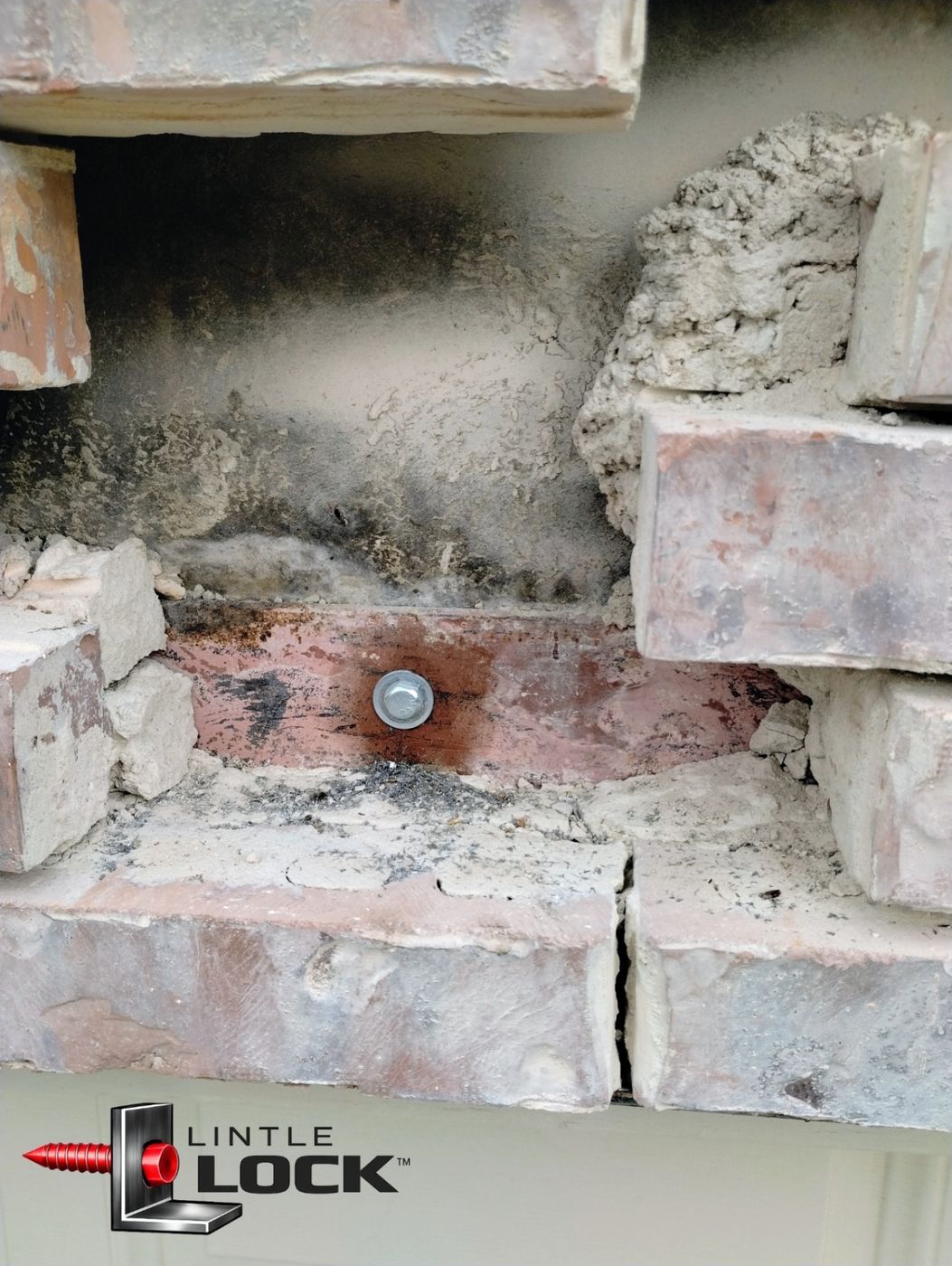 Exposed brick wall above garage door with LintelLOCK™ system installed to correct sagging
