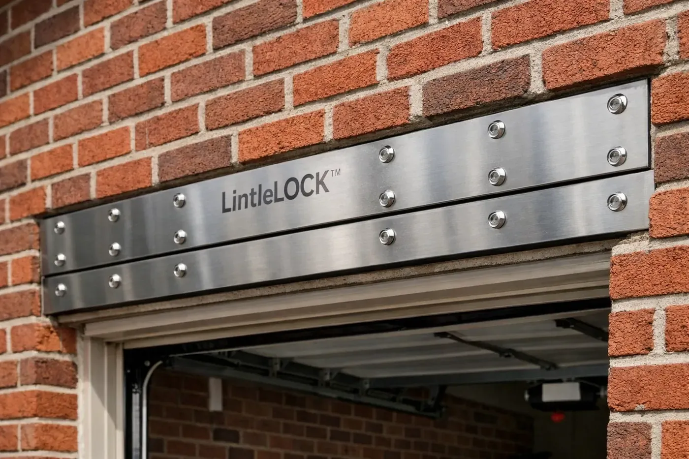 LintelLOCK™ stainless steel reinforcement system installed above garage opening in brick wall