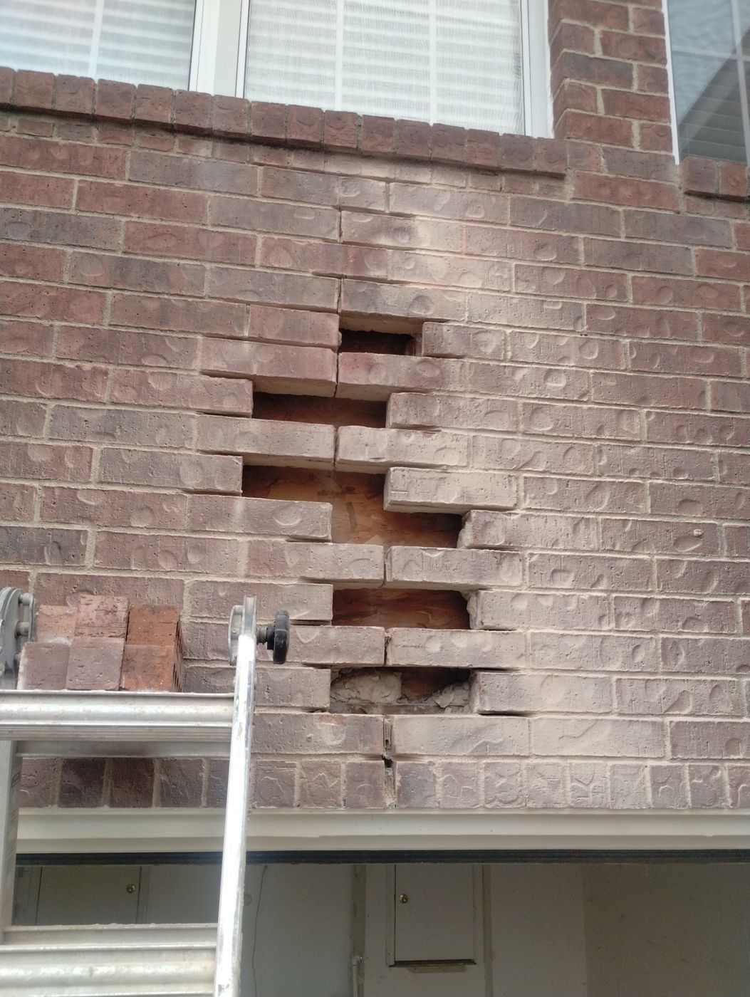 Residential Brick Wall Repair Above Garage Door