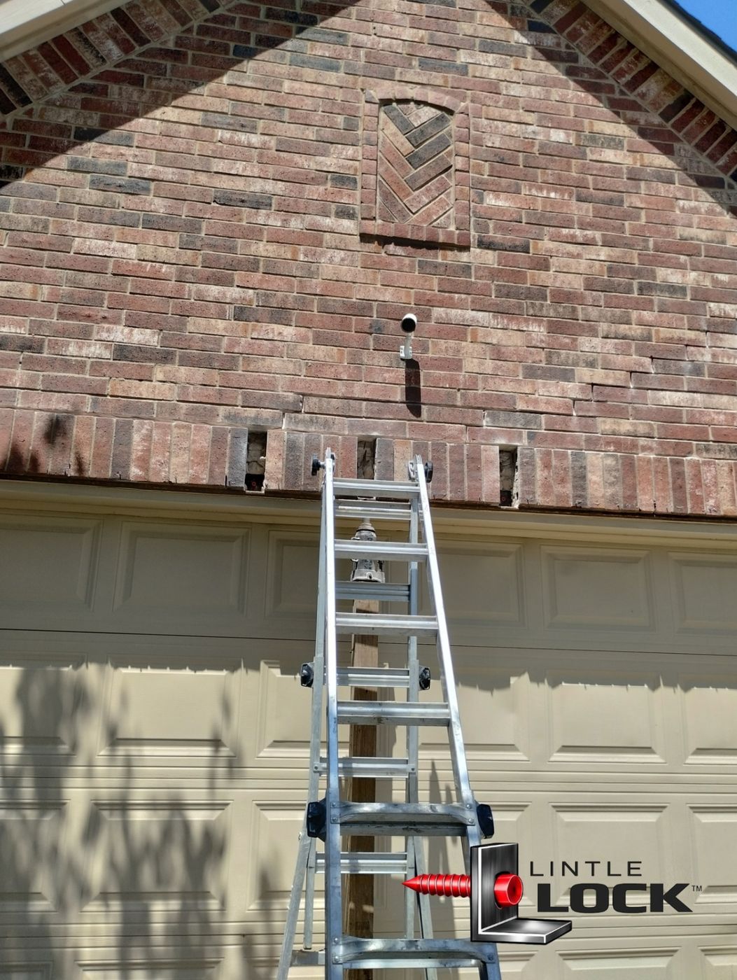 Visible signs of sagging brickwork and cracking above a garage door, prepped for lintel repair using LintelLOCK™ technology.