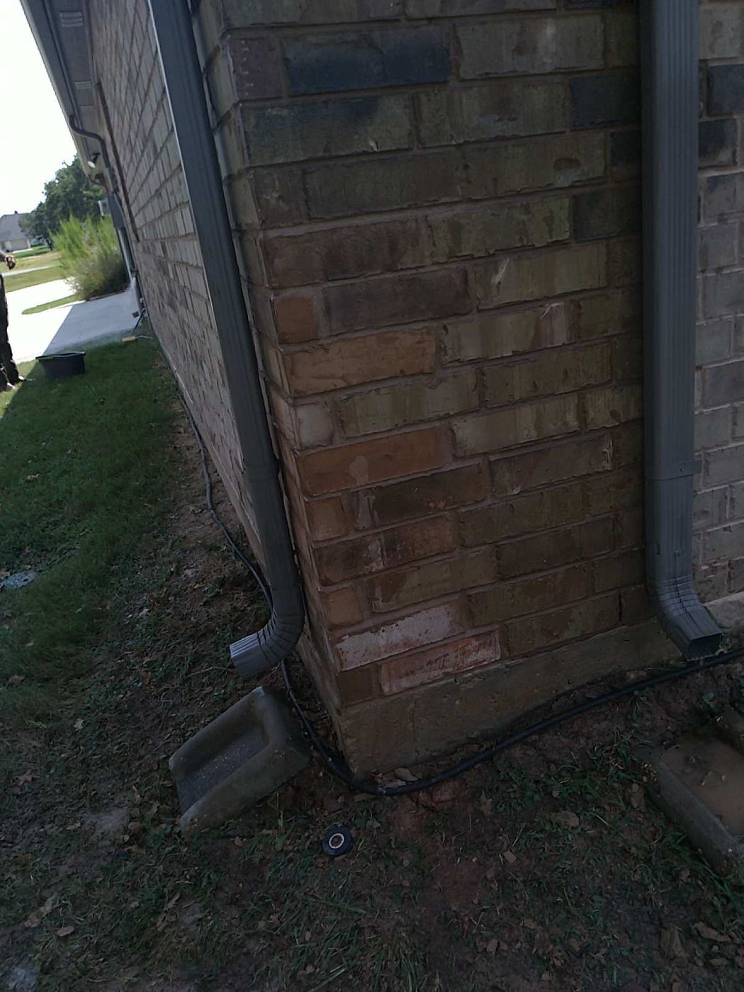 Brick wall corner showing visible mortar discoloration